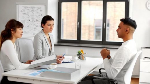 HR managers interviewing a candidate during a job evaluation review in a UAE office
